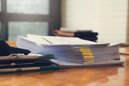 Business and finance concept of office working,Closeup stack of business paper on office deskの写真素材