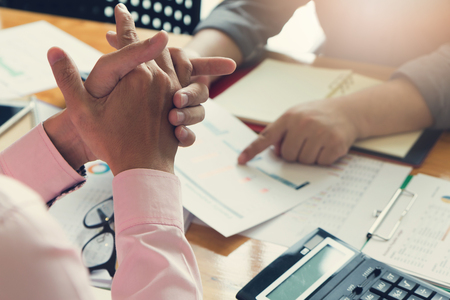 Business and finance concept of office working, Businessman using calculator to discussing sale analysis Chartの写真素材