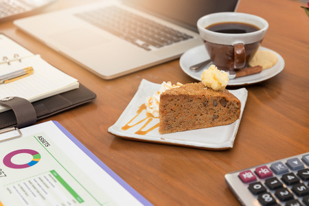 Business and finance concept of working, Working desk in coffee shop with dessert.の写真素材