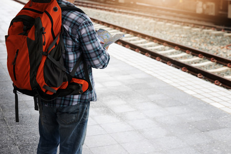 Asian traveler man with belongings waiting for travel by train at Chiang Mai train station, Thailandの写真素材