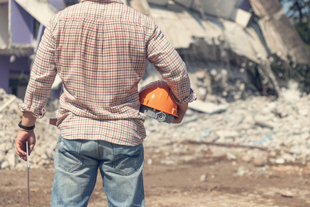 Engineer architect and worker operation control demolish old building.の写真素材