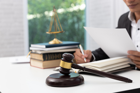 Concepts of law, Lawyer and businessman working and discussing business contract papers in office.の写真素材