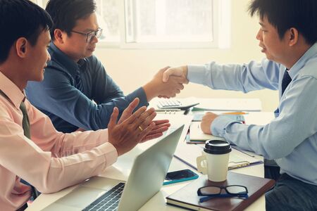 Business and finance concept of office working,Teamwork of Businessmen shaking hand after deal...