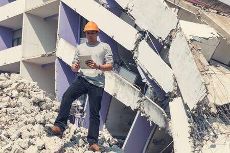 Engineer architect and worker operation control demolish old building.の写真素材