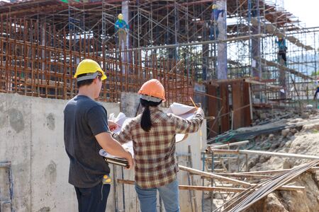 Construction concept of Engineer and Architect working at Construction Site with blue print