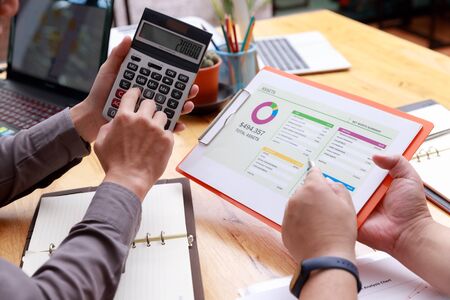 Small and Medium Enterprise Business concept of, Businessman using calculator to calculate Assets Chartの写真素材