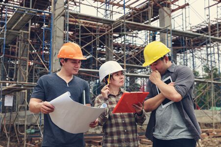 Construction concept of Engineer and Architect working at Construction Site with blue print