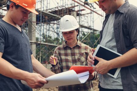 Construction concept of Engineer and Architect working at Construction Site with blue printの写真素材