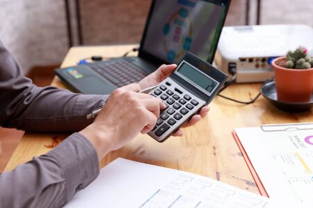 Small and Medium Enterprise Business concept of ,Businessman using calculator to calculate Assets...