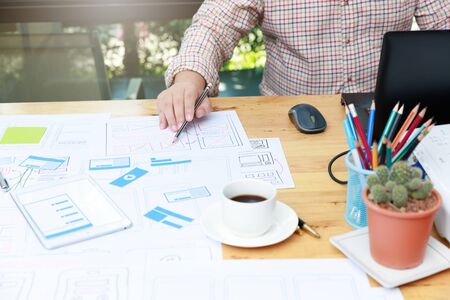 Graphic designers work together with UX UI designer planning application template layout framework...