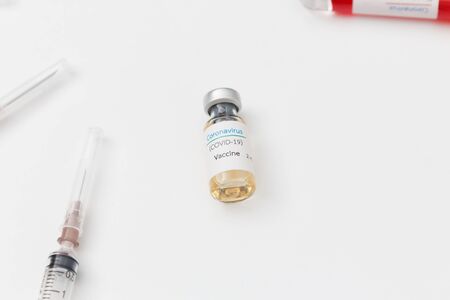 Close up covid-19 vaccine bottle in laboratory.
