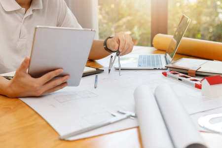Engineer and Architect concept, Engineer Architects  and Interior designer working with blueprints