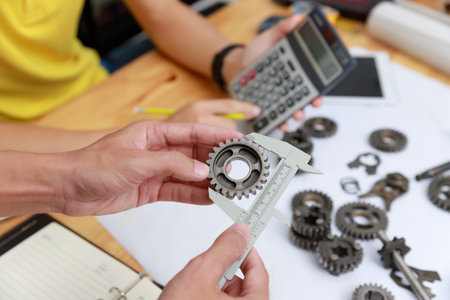 Engineer discussing and designing about mechanical gear parts in office.の写真素材