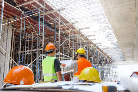 Construction concept of Engineer and Architect working at Construction Site with blue printの写真素材