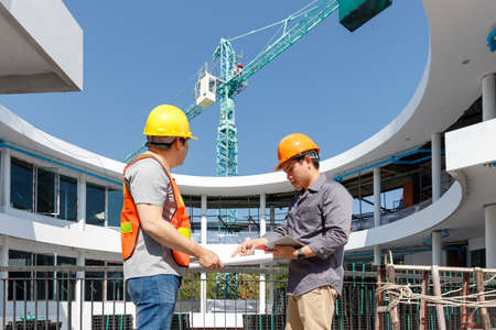 Construction concept of Engineer and Architect working at Construction Site with blue printの写真素材