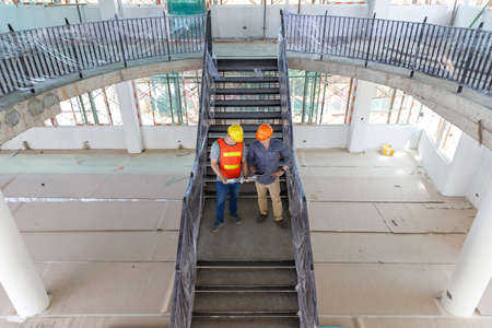 Construction concept of Engineer and Architect working at Construction Site with blue print