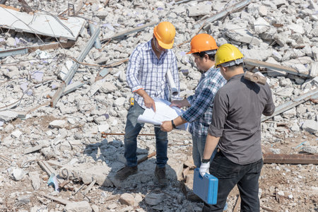 Engineer architect and worker operation control demolish old building.の写真素材
