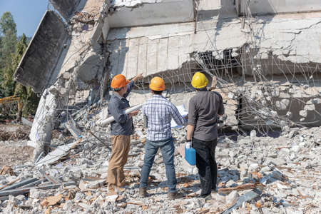 Engineer architect and worker operation control demolish old building.の写真素材