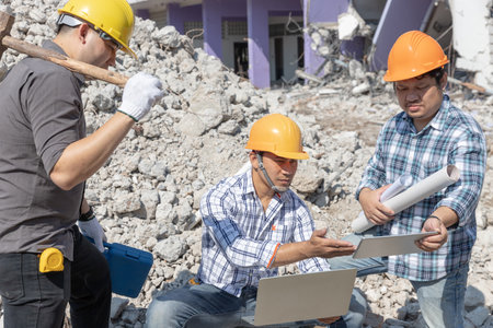 Engineer architect and worker operation control demolish old building.の写真素材