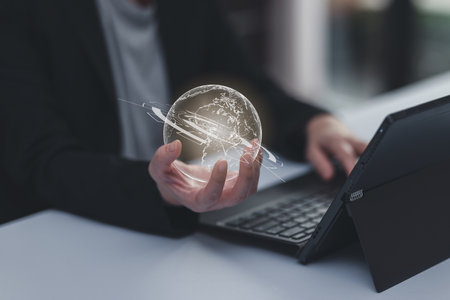 Concept of searching data networking and internet, Businesswoman wearing a suit holding hologram globe  using smartphone searching data or browsing online data internet data for informationの写真素材