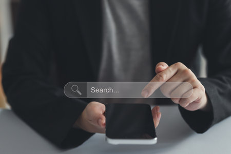 Concept of searching data networking and internet, Businesswoman wearing a suit using smartphone searching data or browsing online data internet data for informationの写真素材