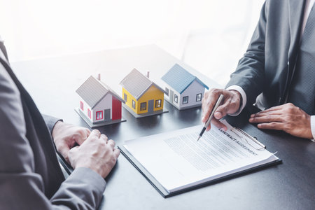 Home sales,home rental and real estate concept.Customer sign the document after real estate agent explain about the terms of the home purchase or rental agreementの写真素材
