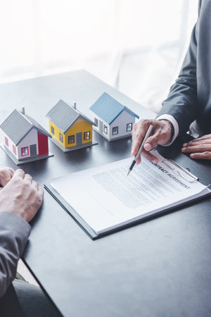 Home sales,home rental and real estate concept.Customer sign the document after real estate agent explain about the terms of the home purchase or rental agreementの写真素材