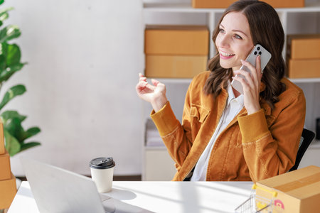 Concept of parcel delivery and selling online, Seller or retailer using  smartphone to contact customers who order from online stores to confirm their orders before sending the parcel packageの写真素材