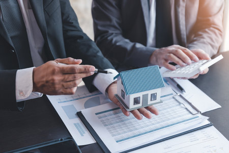 Finance and real estate investment concept, Businessman present business finance investment plan with his partner, Investor colleagues discussing new investment plan by financial graph analytic dataの写真素材