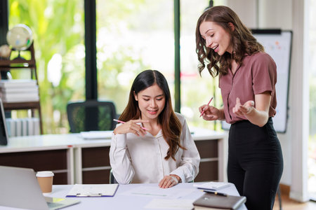 Concept of business office woman working,à¸º Businesswoman working with investment plan with her partner and analyzing document business investment graph data by using calculator and laptopの写真素材