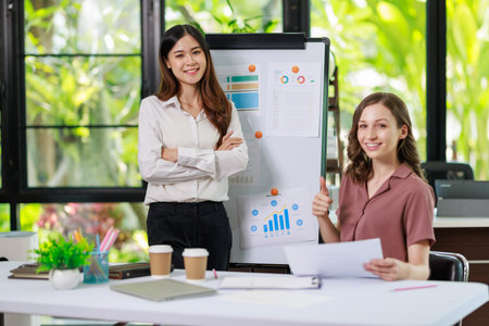 Concept of business office woman working,à¸º Businesswoman working with investment plan with her partner and analyzing document business investment graph data by using calculator and laptopの写真素材