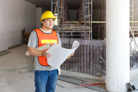 Construction concept of Engineer and Architect working with construction model and blueprint at construction site, Engineer and Architect discussing construction plan at building siteの写真素材