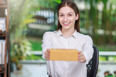 Concept of parcel delivery and selling online,Retailer writing customer detail on parcel box and...