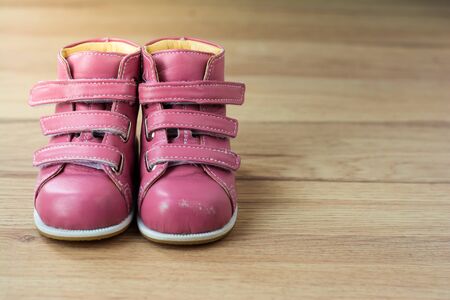 Pink Kids Shoes on wood background,Children's leather bootsの写真素材