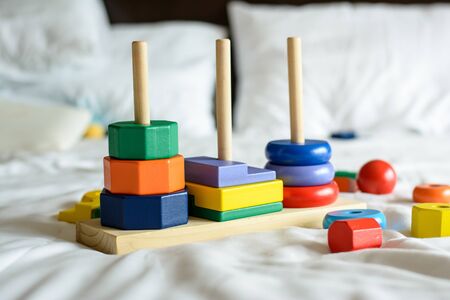 Wooden colorful blocks and sorting shapes on the bedの写真素材