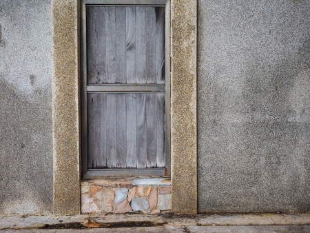 Wooden doors on the wall of cementの写真素材
