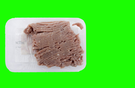 Minced meat on green background with clipping pathの写真素材
