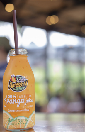 chiang mai, Thailand, 12 April 2019 : 100% tangerine orange juice in bottle product at cafe amazon.のeditorial素材