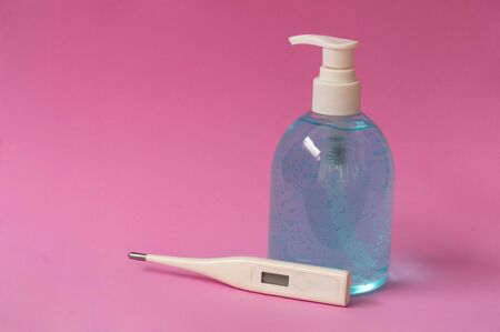 Coronavirus prevention with hand sanitizer, alcohol gel and thermometer.の写真素材