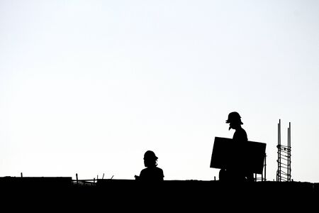 Silhouette workers under construction and construction site.の写真素材