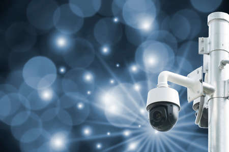 Modern surveillance cameras in bokeh, blurred background, the concept of surveillance and tracking.