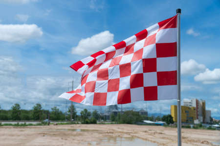 The white-red chess flag on the racetrack.の写真素材