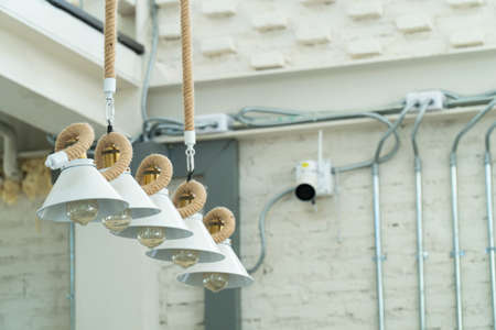 Chandelier led ceiling lighting in the white building. Design, decoration.