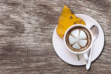 White coffee mugs and Mocha on old wooden tables.の写真素材