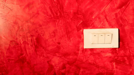 Red painted loft walls and light switches.