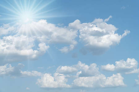 sunny background blue sky with white clouds and sunの写真素材