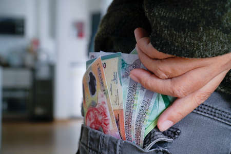 Banknotes in pants pocket, close-up spending money.の写真素材