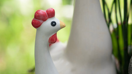 Ceramic chicken in the garden. Selective focus and shallow depth of field.の写真素材