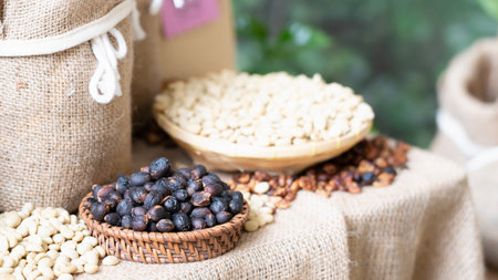 Close up of nuts in a wooden bowl on sackcloth with blurred backgroundの写真素材