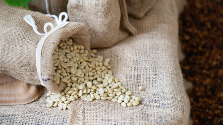 Coffee beans in jute bag on burlap background.の写真素材